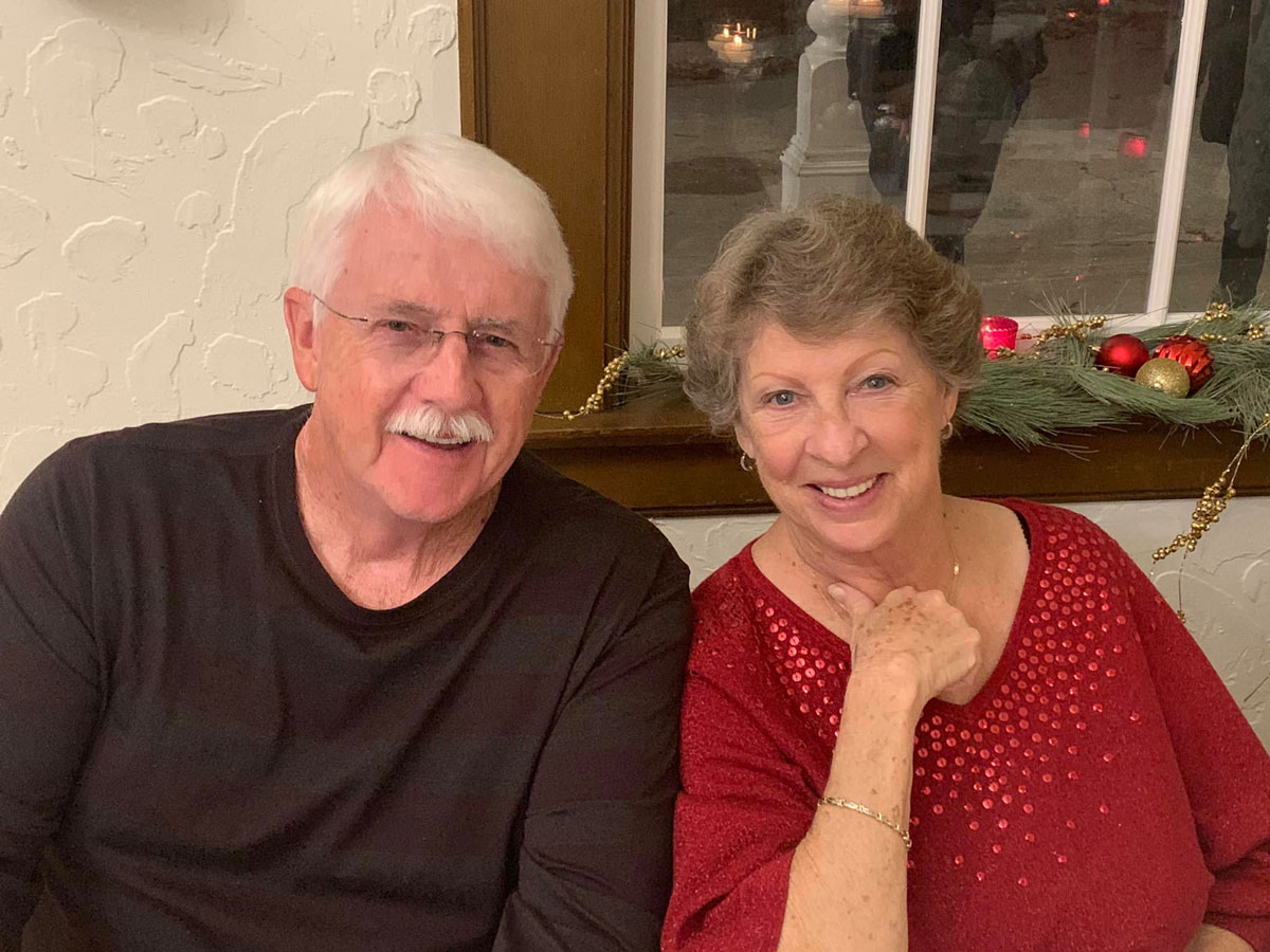 An older couple sitting together smiling